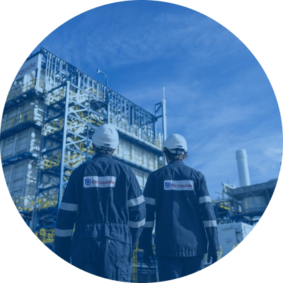 Two people wearing helmets reading a manual